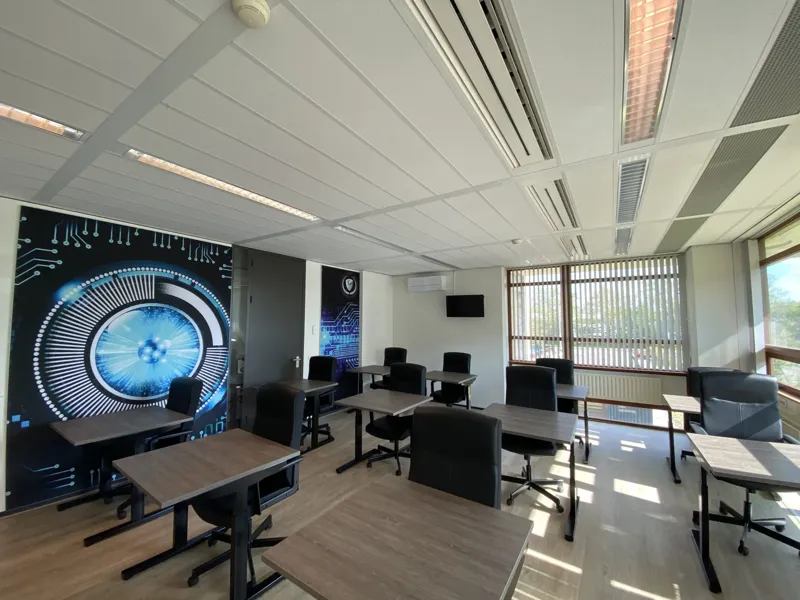 Bright classroom with wall print and a view of the greenery