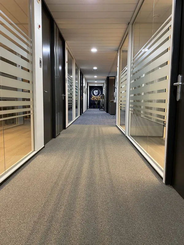 Corridor towards the reception area with the IACA logo on the back wall