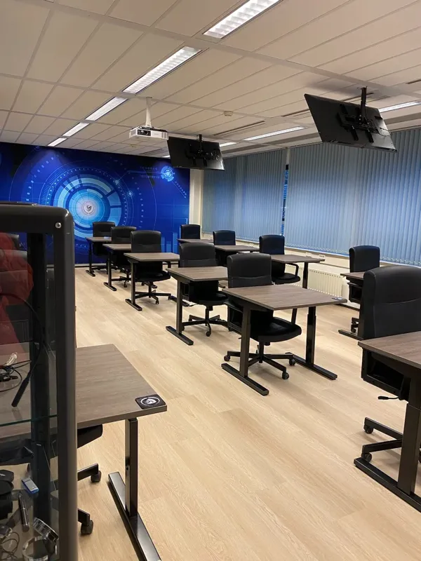 Classroom in classroom layout with screens and a projector
