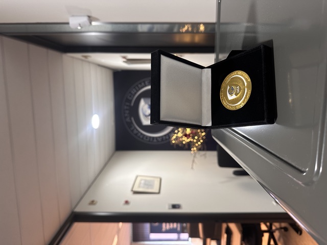 The Registered Open Source Intelligence Expert-A® coin in a presentation case at the entrance