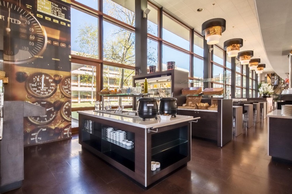 The restaurant at the training location in Gilze-Rijen, with a buffet and seating by the window